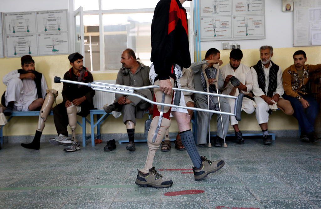 A man learns how to walk with his new prosthetic at a Red Cross physical rehabilitation center