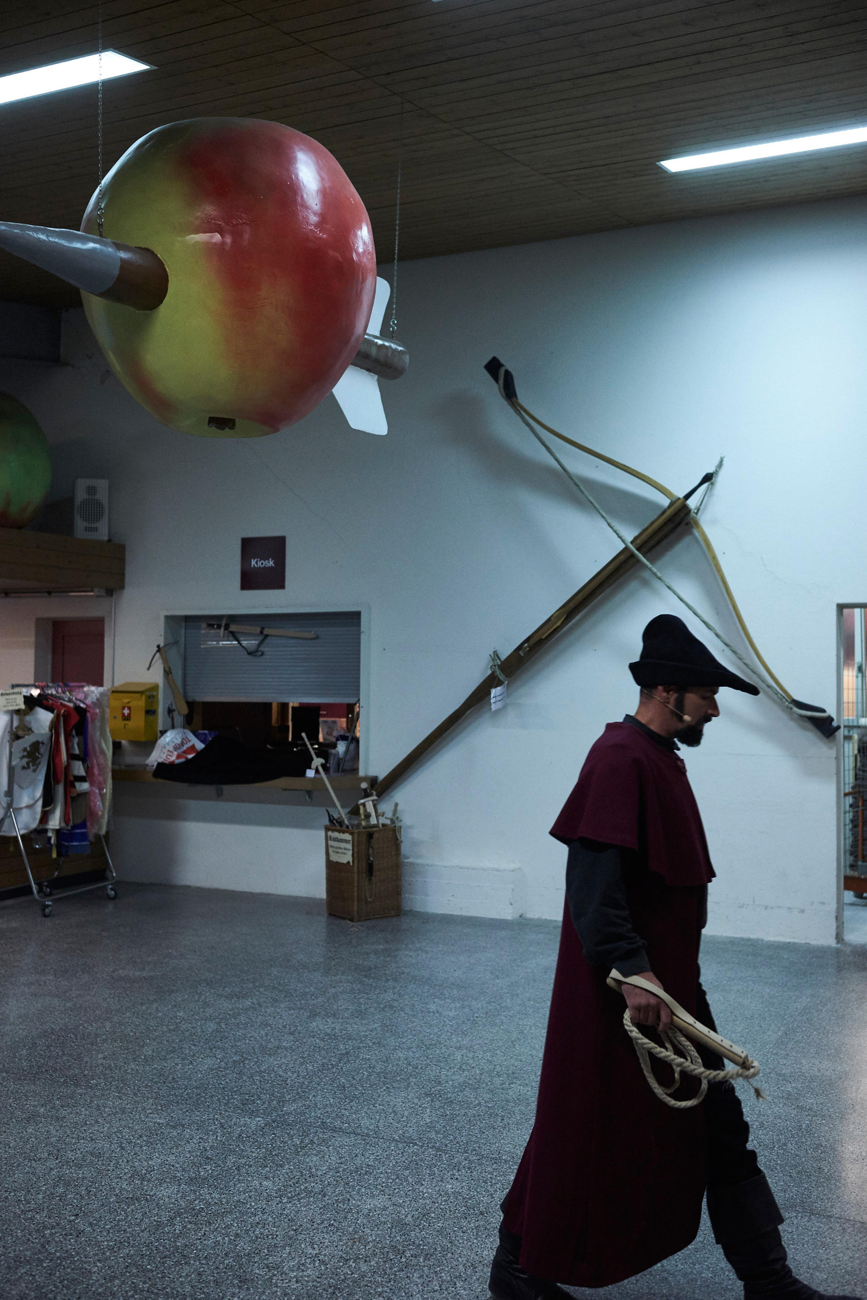 An actor in costume walks through the foyer