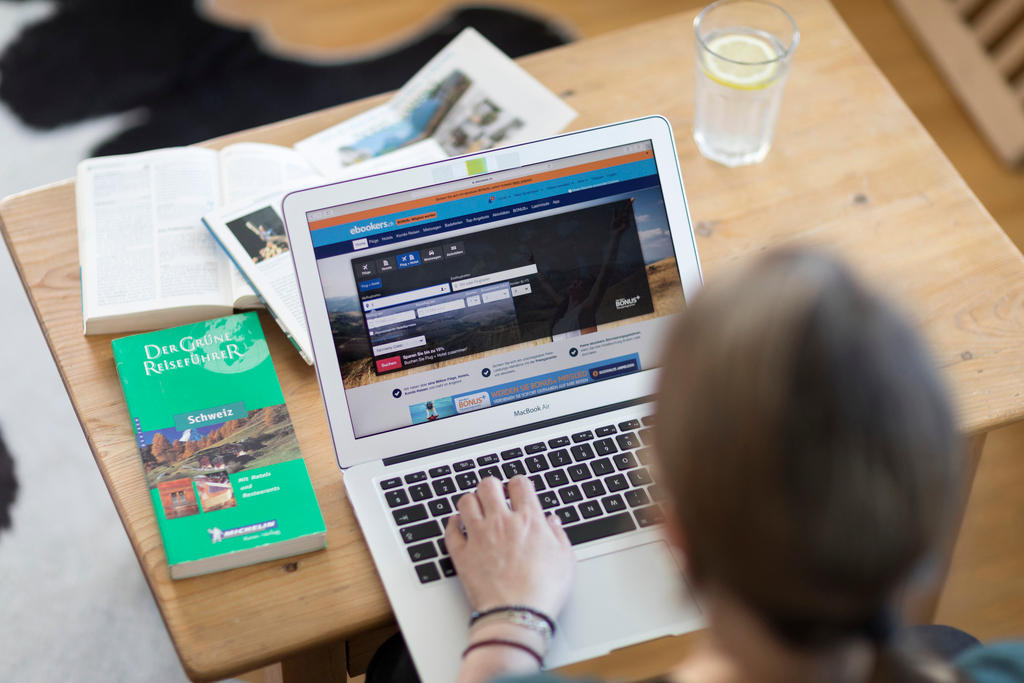 Man using computer to book hotel room