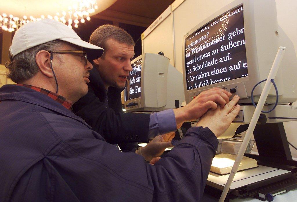 Blind man trying out a special electronic reading device