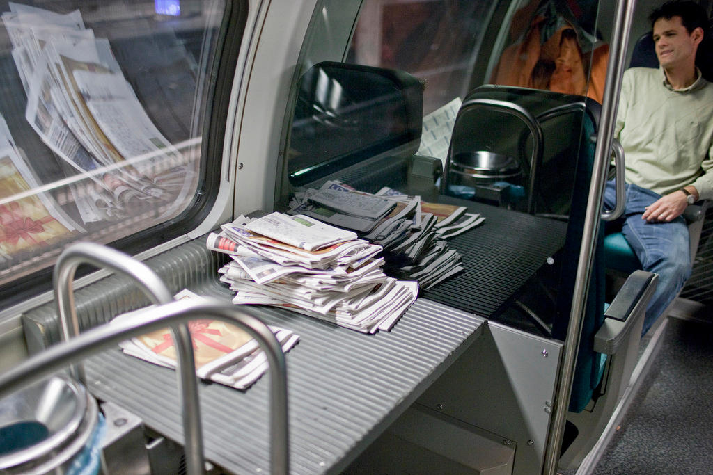 swiss train, with pile of newspapers
