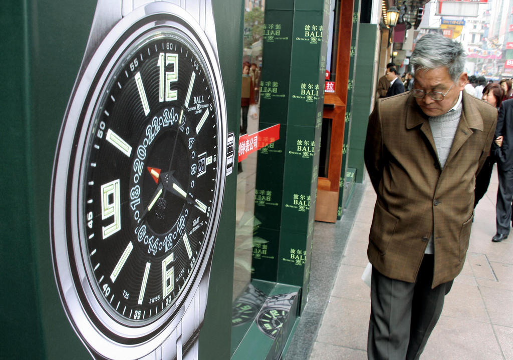 chinese man next to watch poster