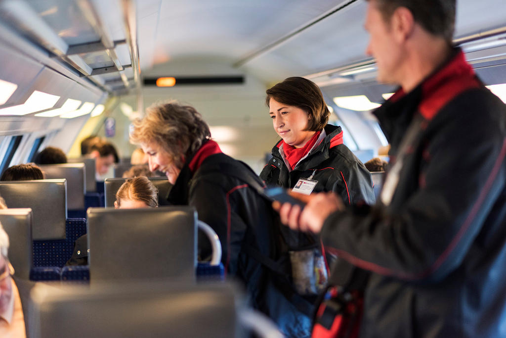 Passengers and ticket inspectors on a rail carriage