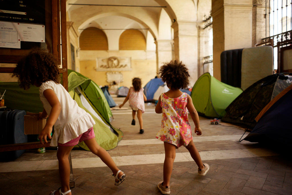 bambini giocano sotto i portici di una basilica romana
