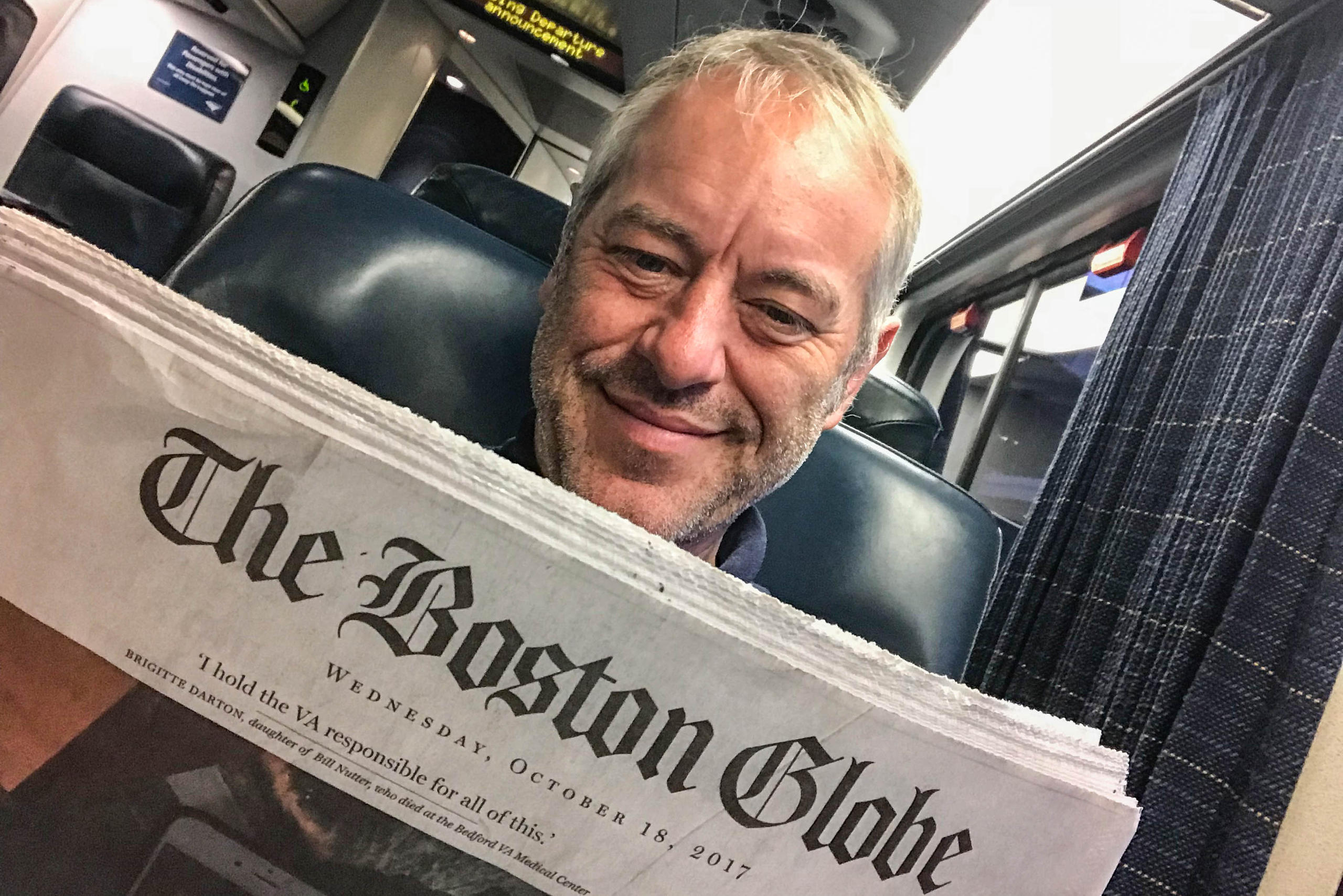 Bruno Kaufmann on a bus reading the Boston Globe