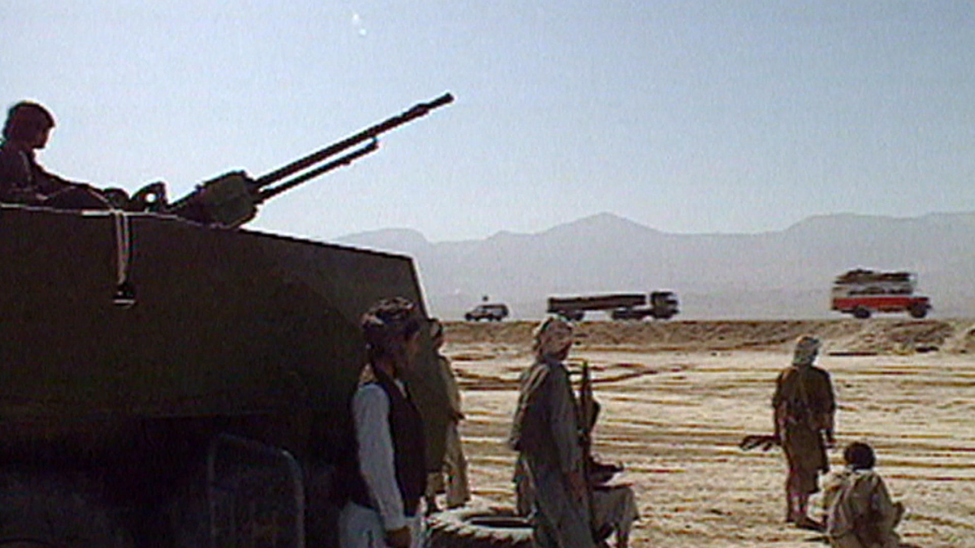 Tank and armed men, western trucks