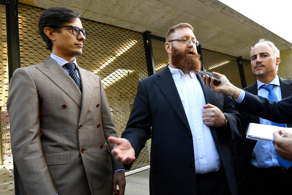 The bearded Sperisen (centre) with his lawyers