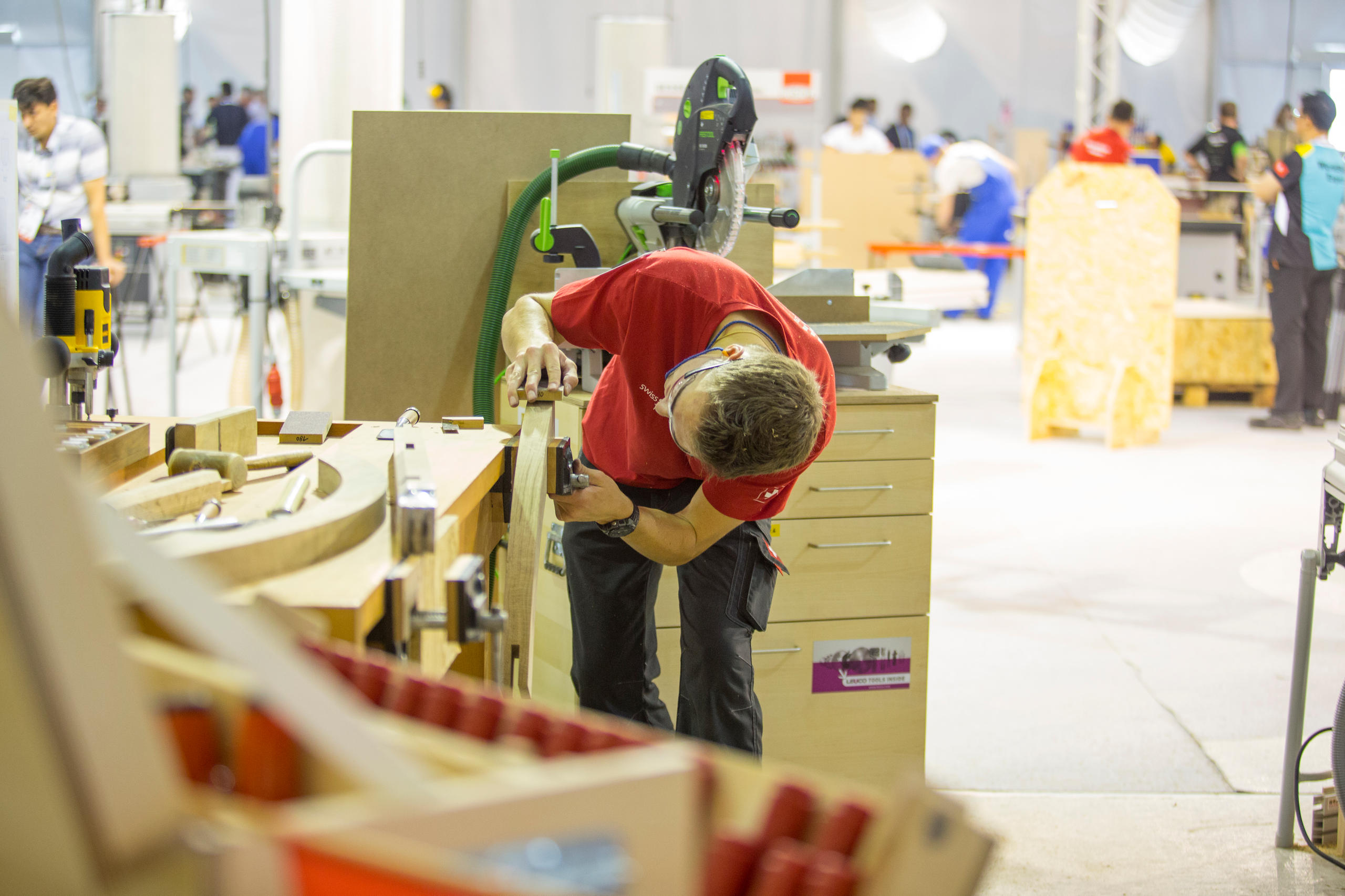 A man works on a wooden construction