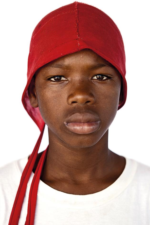 Boy wear a red hat, Razza Umana, 2016