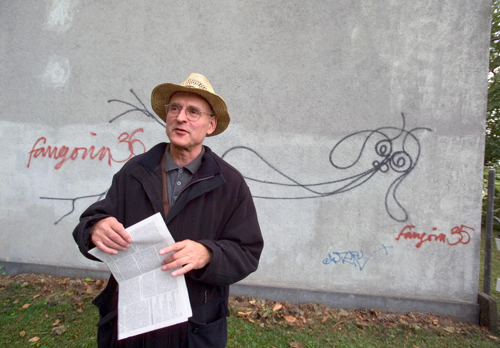 Harald Naegeli poses in front of his artwork Undine