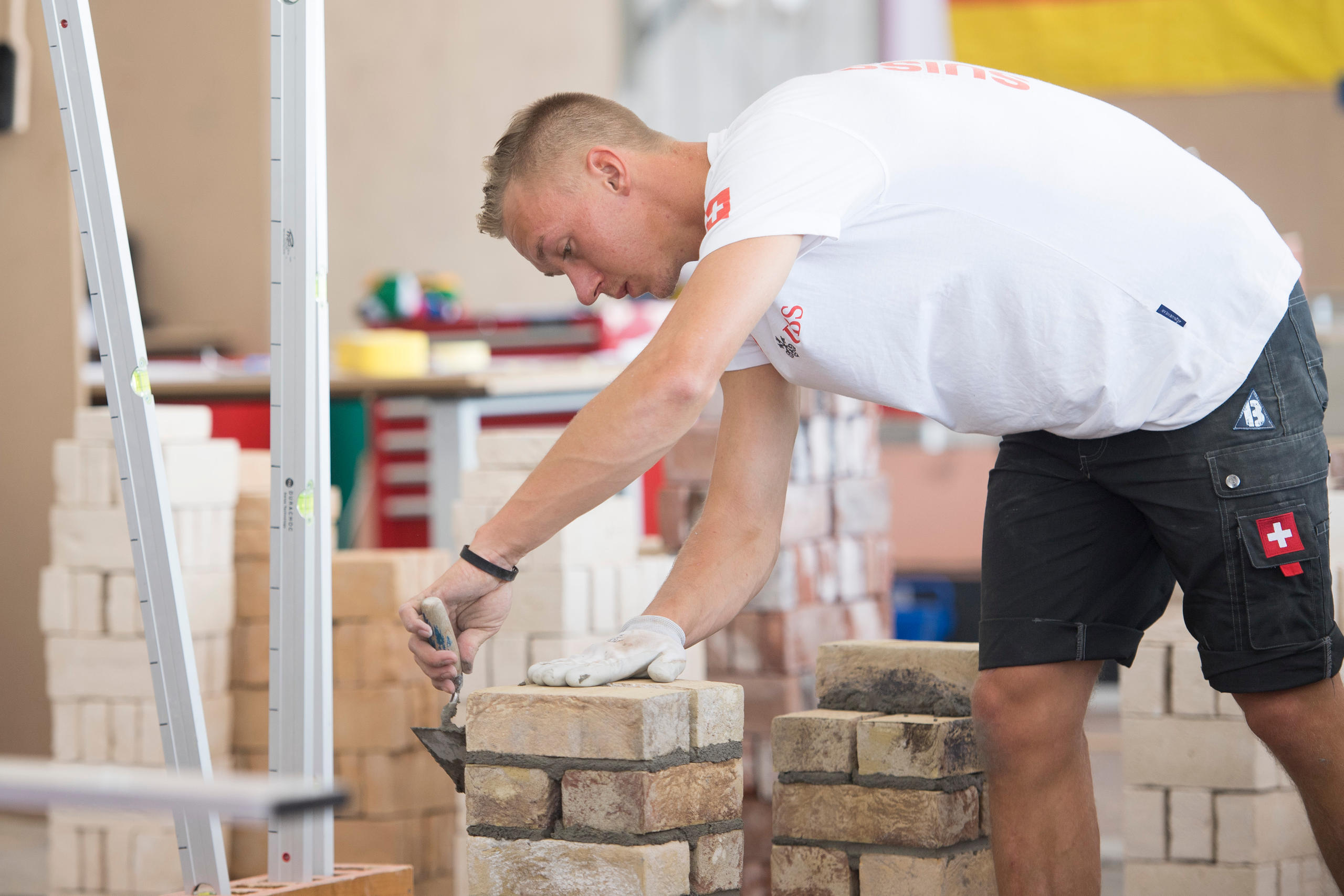 A man builds a brick wall