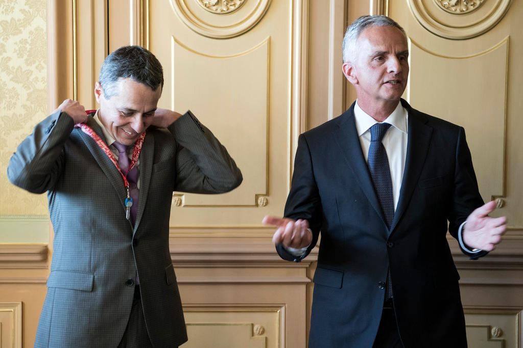 Two men, one with key on neck