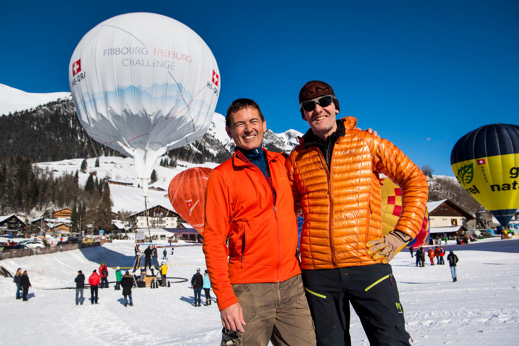 Two men stand before a Air Balloon