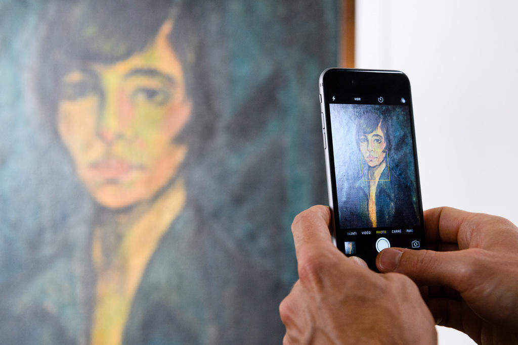 A painting is photographed by a smartphone