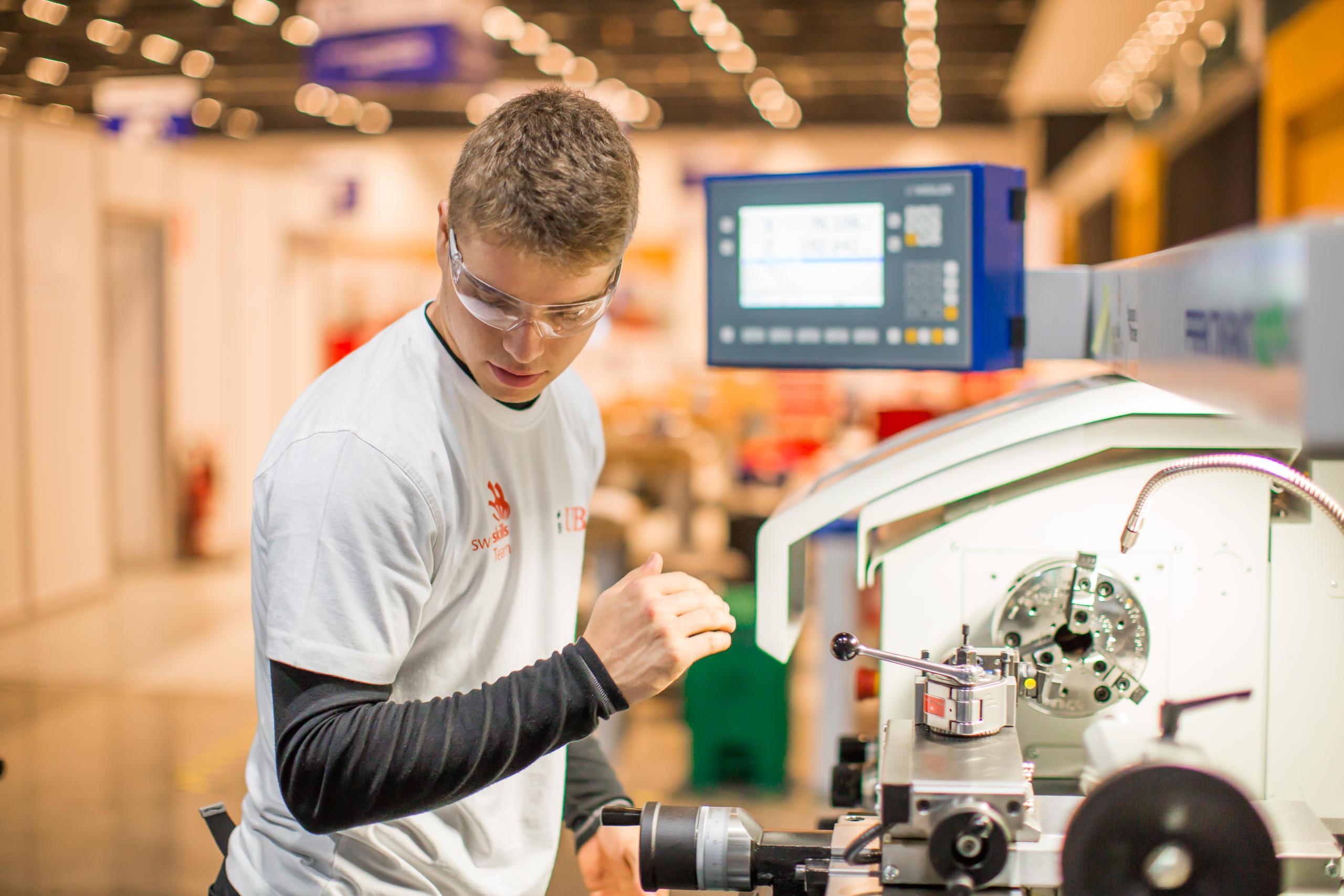 A man working at a machine in a workshop