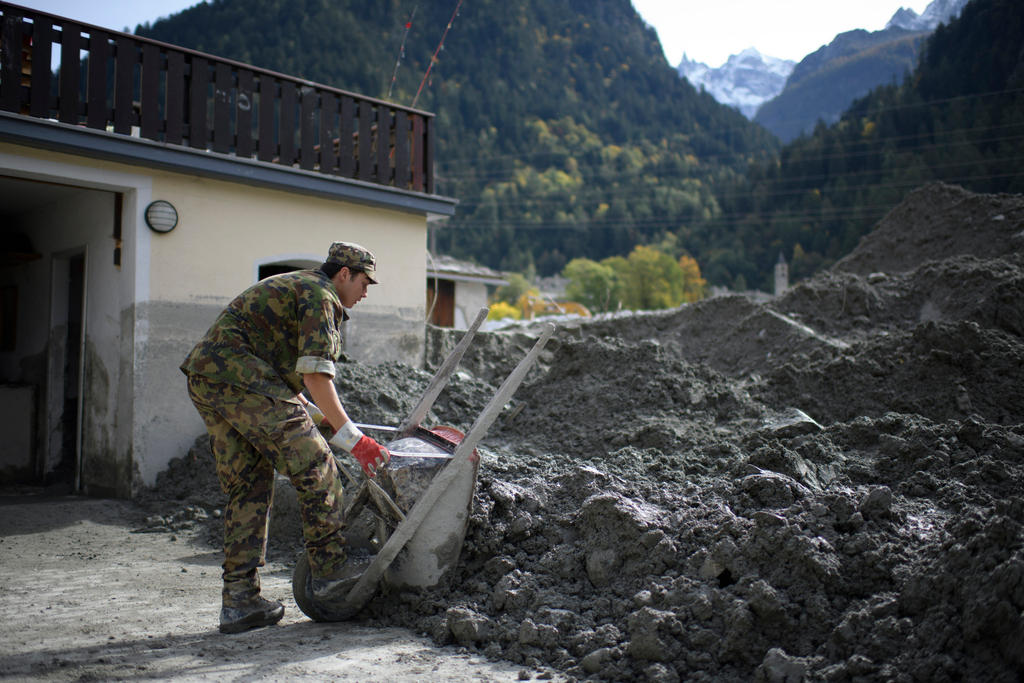 soldier clearing rocks and mud