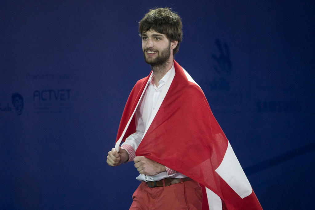 Man with Swiss flag around his shoulders