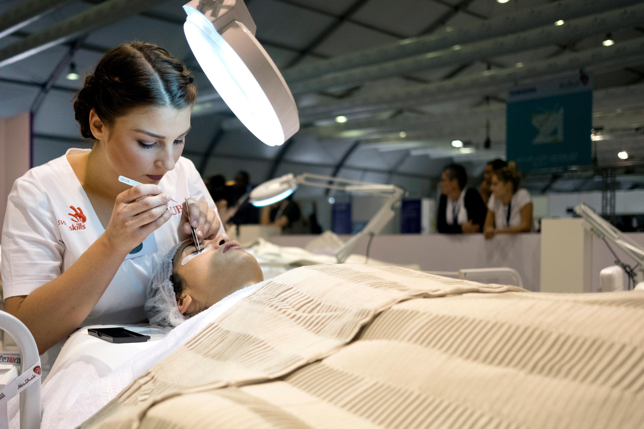 A beautician works on a client