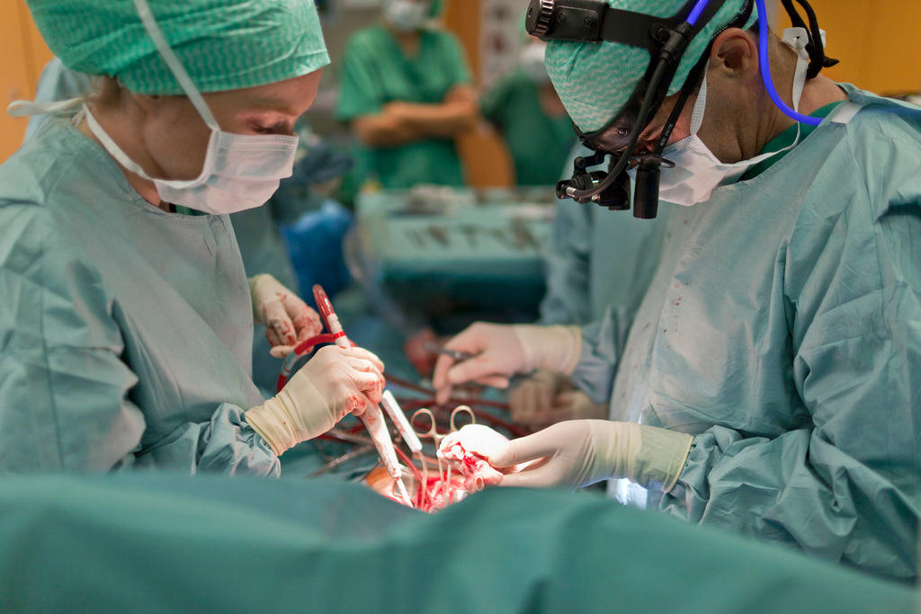Doctors carry out a heart-transplant operation on a seven-year-old child.