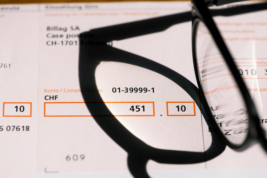 Invoice for Billag bill and a pair of glasses