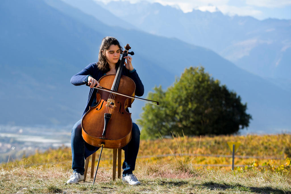 Cellist Estelle Revaz plays her instrument during the harvest of the world s smallest vineyard in La Vigne