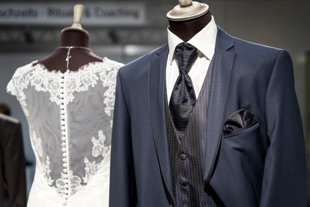 A wedding dress and tuxedo on mannequins at a wedding exhibition in Zurich