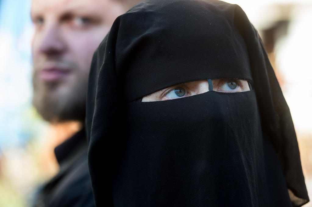 Black burka covering the face of a woman