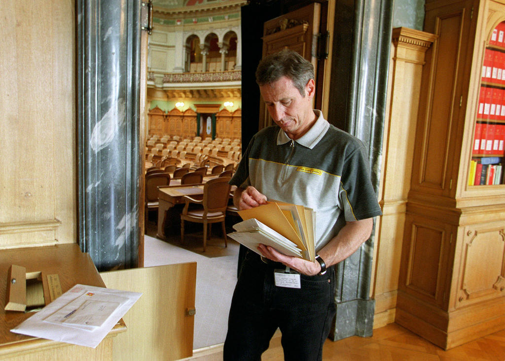 A postman at the Swiss parliament in the lobby of the House of Representatives