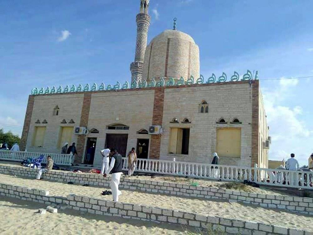People walk outside a mosque