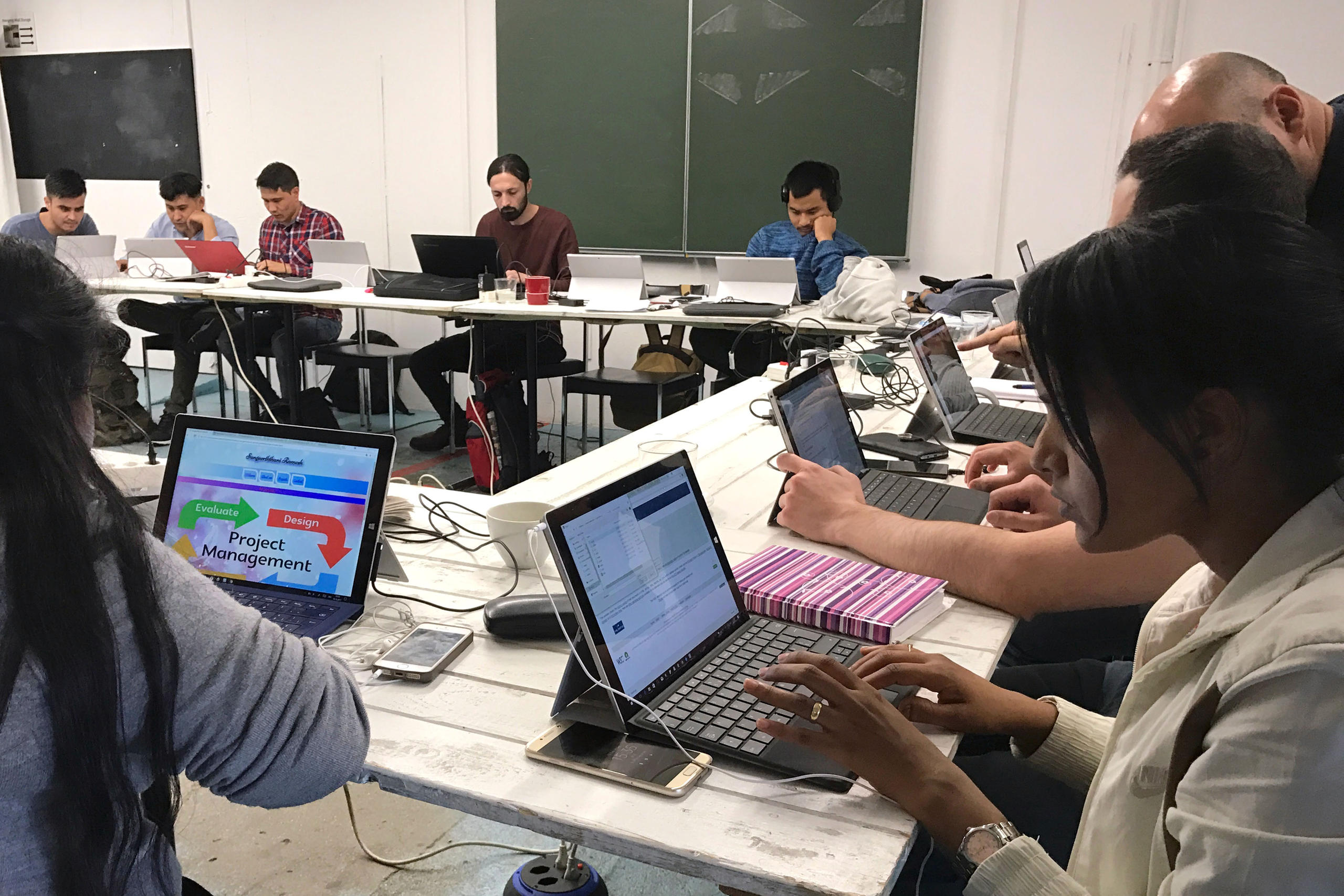 Students in a room working at the computer.