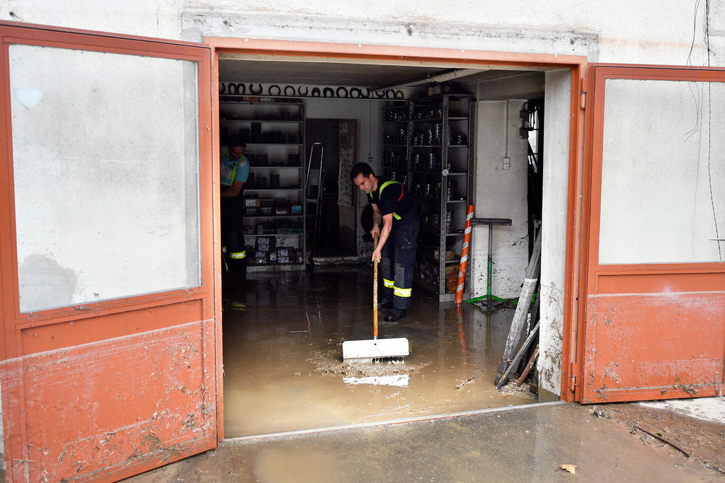 A man clears up after floods in Uerkheim