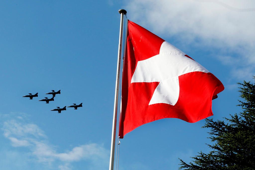 Swiss flag with jets in background