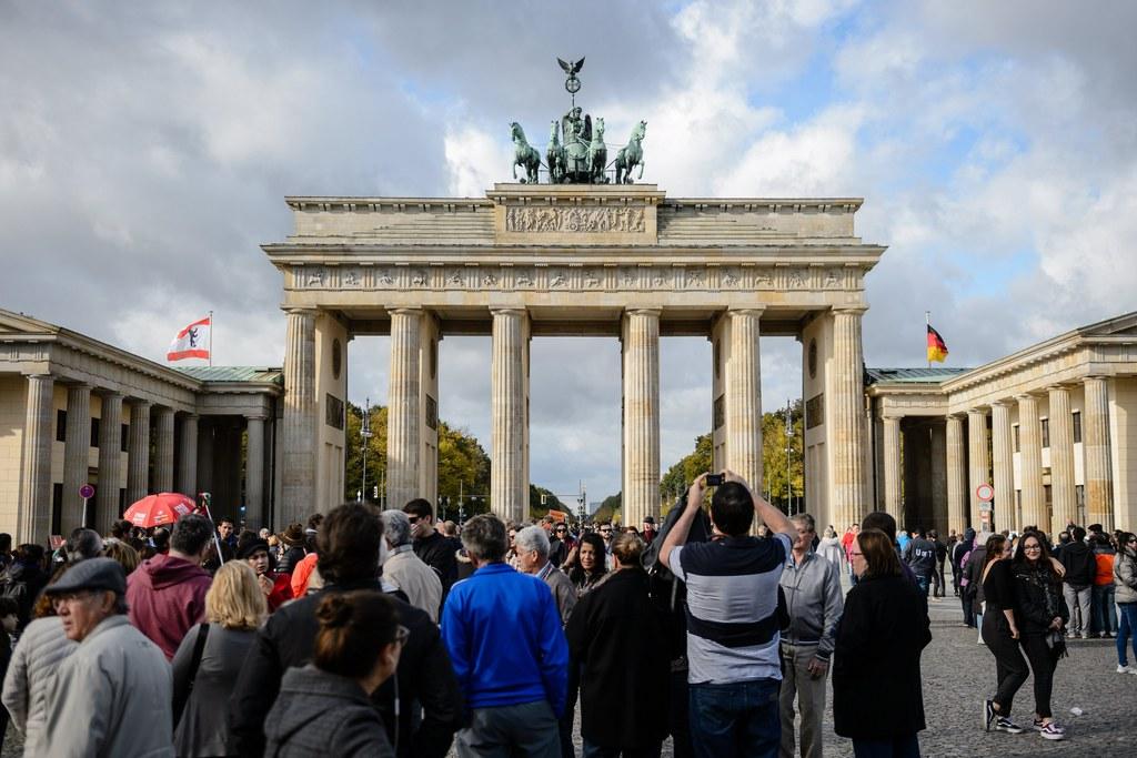 Tourists visit the Brandenburg Gate in Berlin