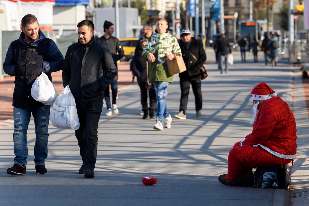 A beggar disguised as Father Christmas on Plainpalais Square in Geneva on December 3, 2017