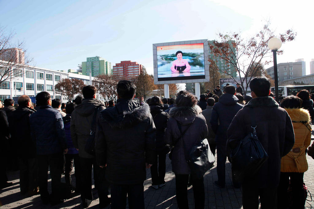 People watch the news broadcast in North Korea
