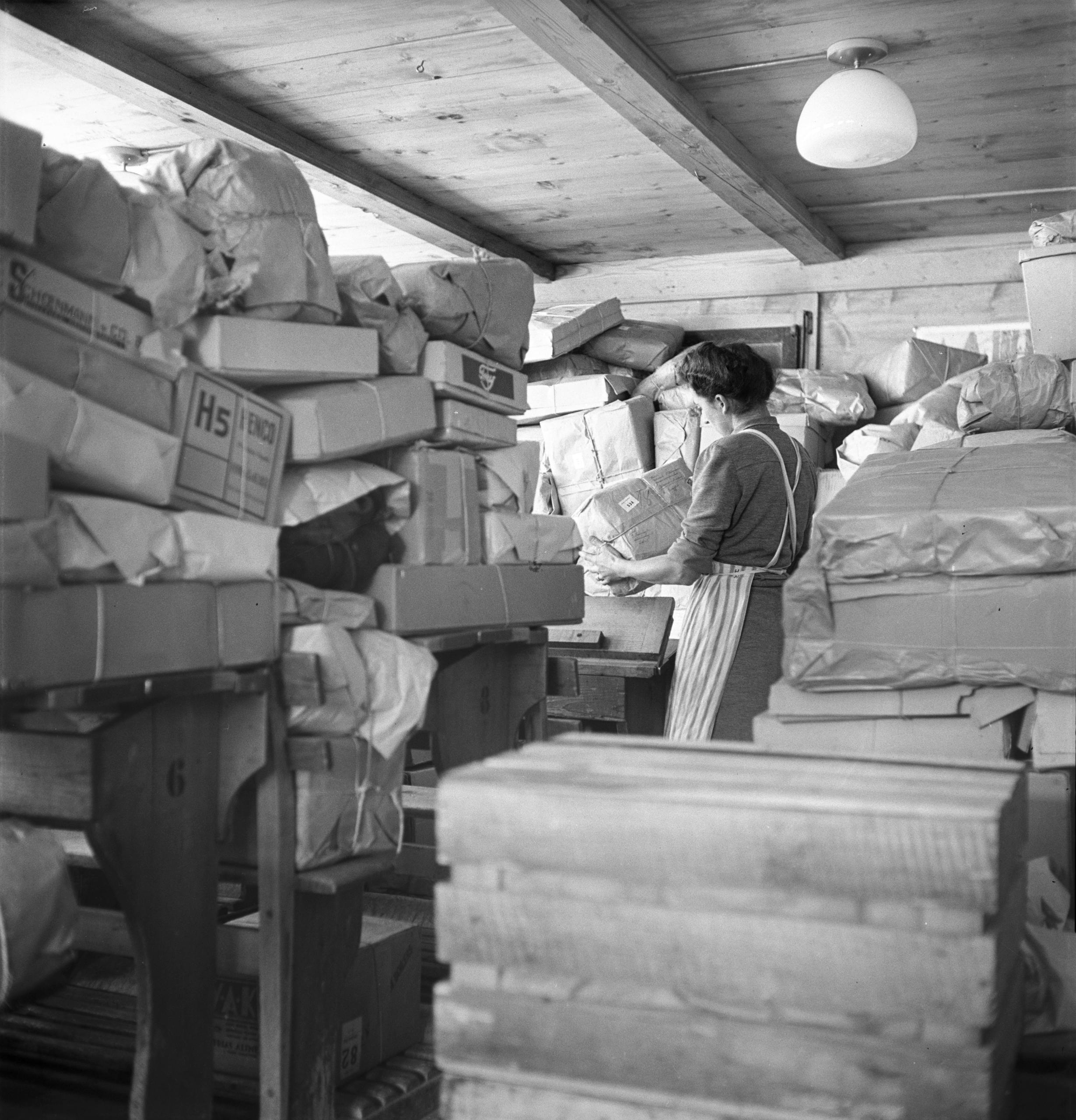 Woman standing among many parcels