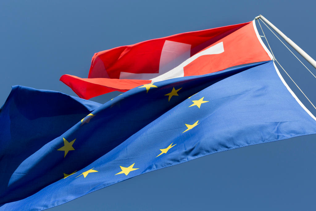 A hoisted EU and Swiss flag fly in the wind in Zurich, Switzerland, on May 18, 2015.