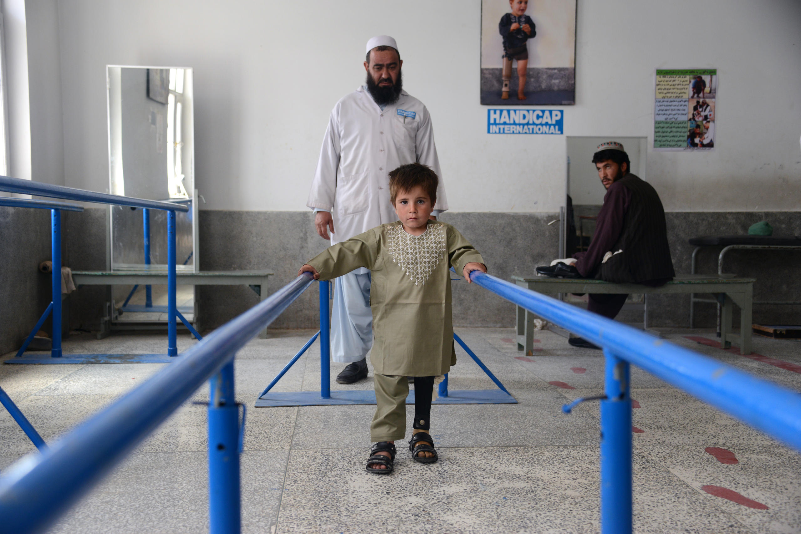 Afghani boy learning to walk with prosthesis
