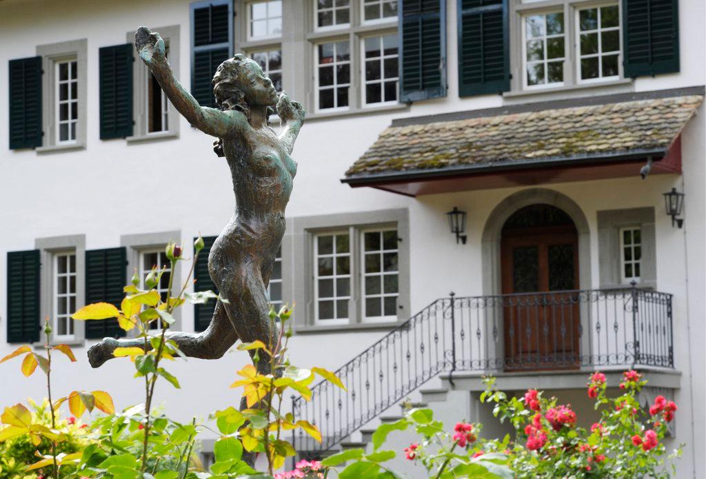 Exterior shot of C.G. Jung Institute, with statue in foreground