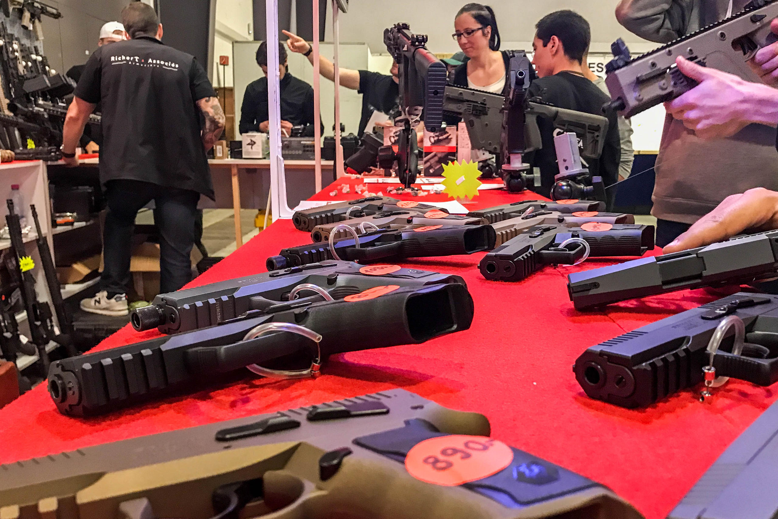Gun fans check out new weapons at a stand at the 24th International Gun Fair in Lausanne
