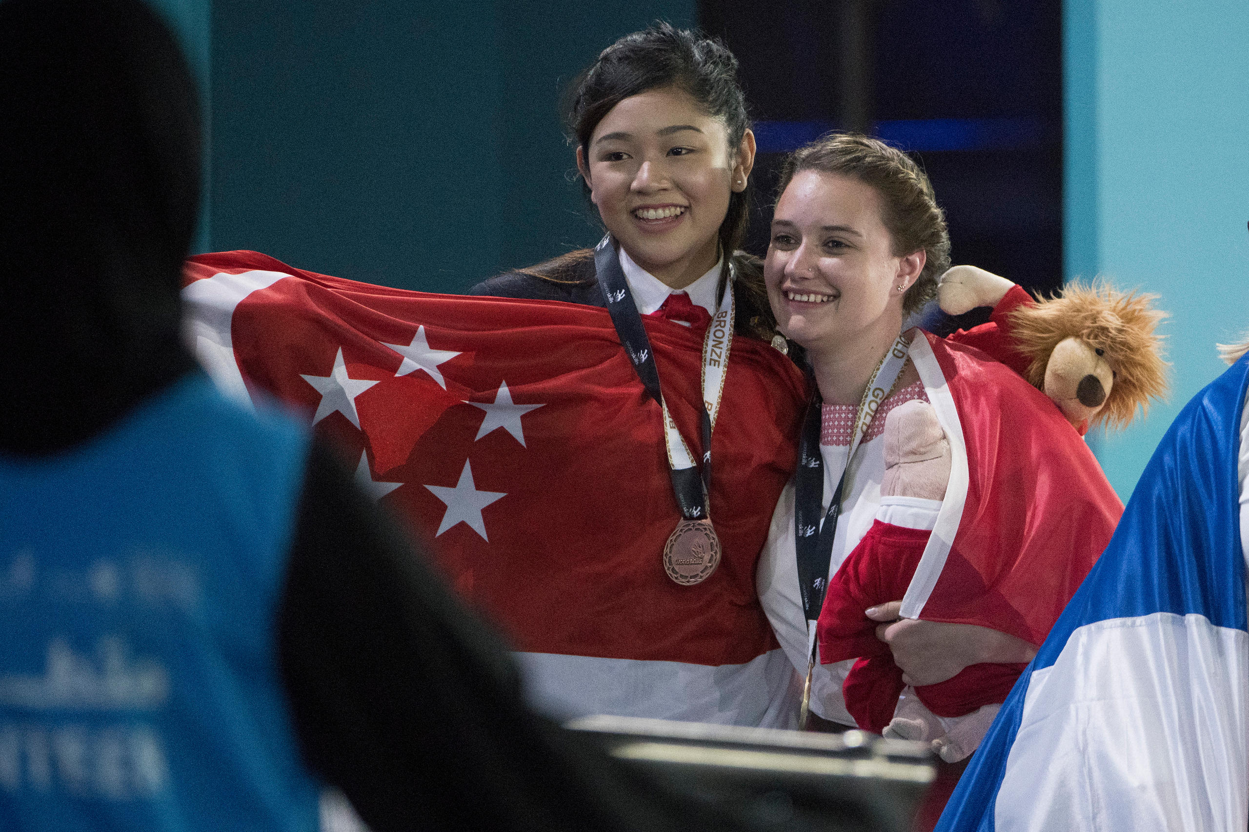Tuor and another medalist in her category celebrate their wins at WorldSkills