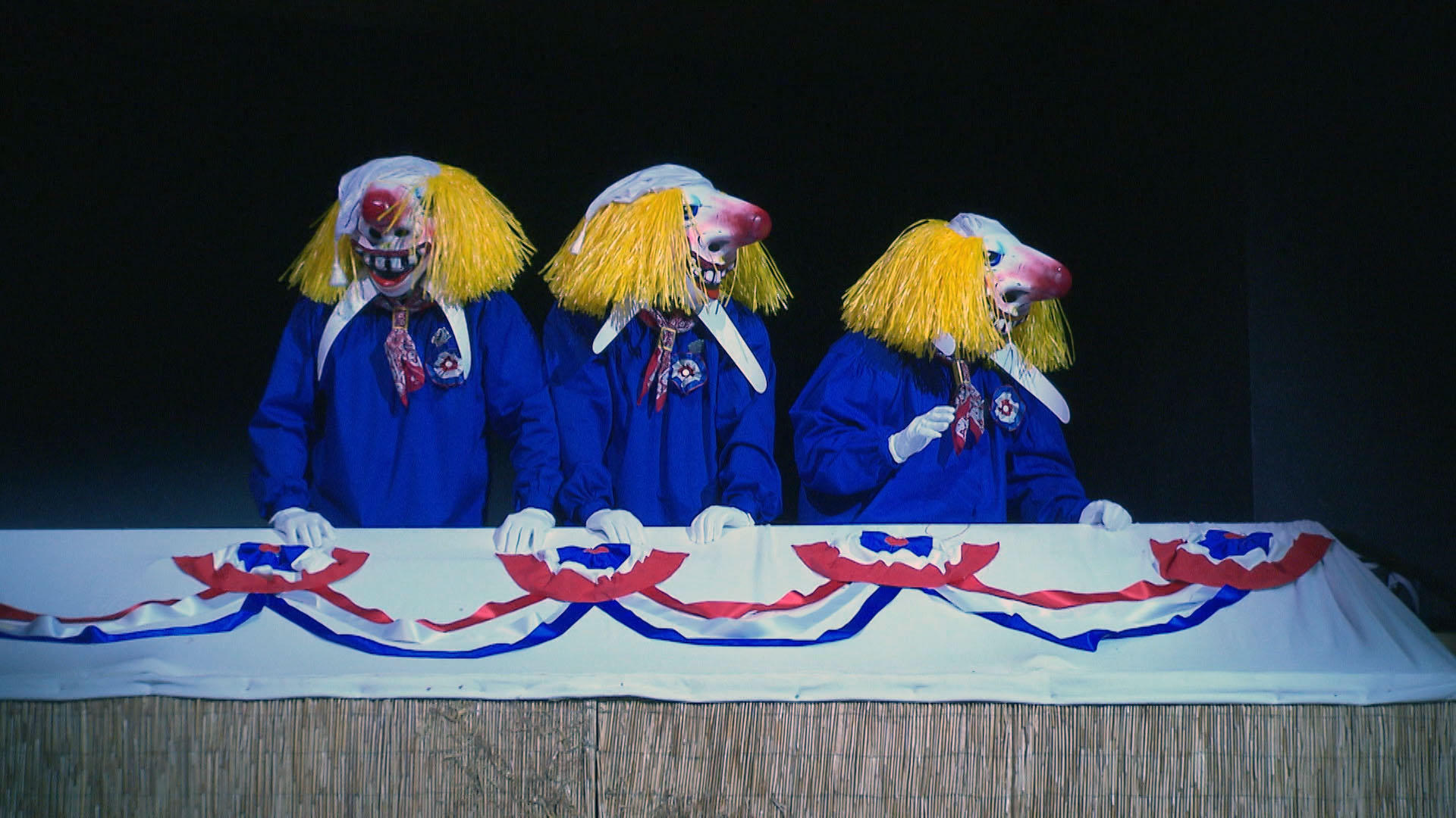 3 people wearing Fasnacht masks