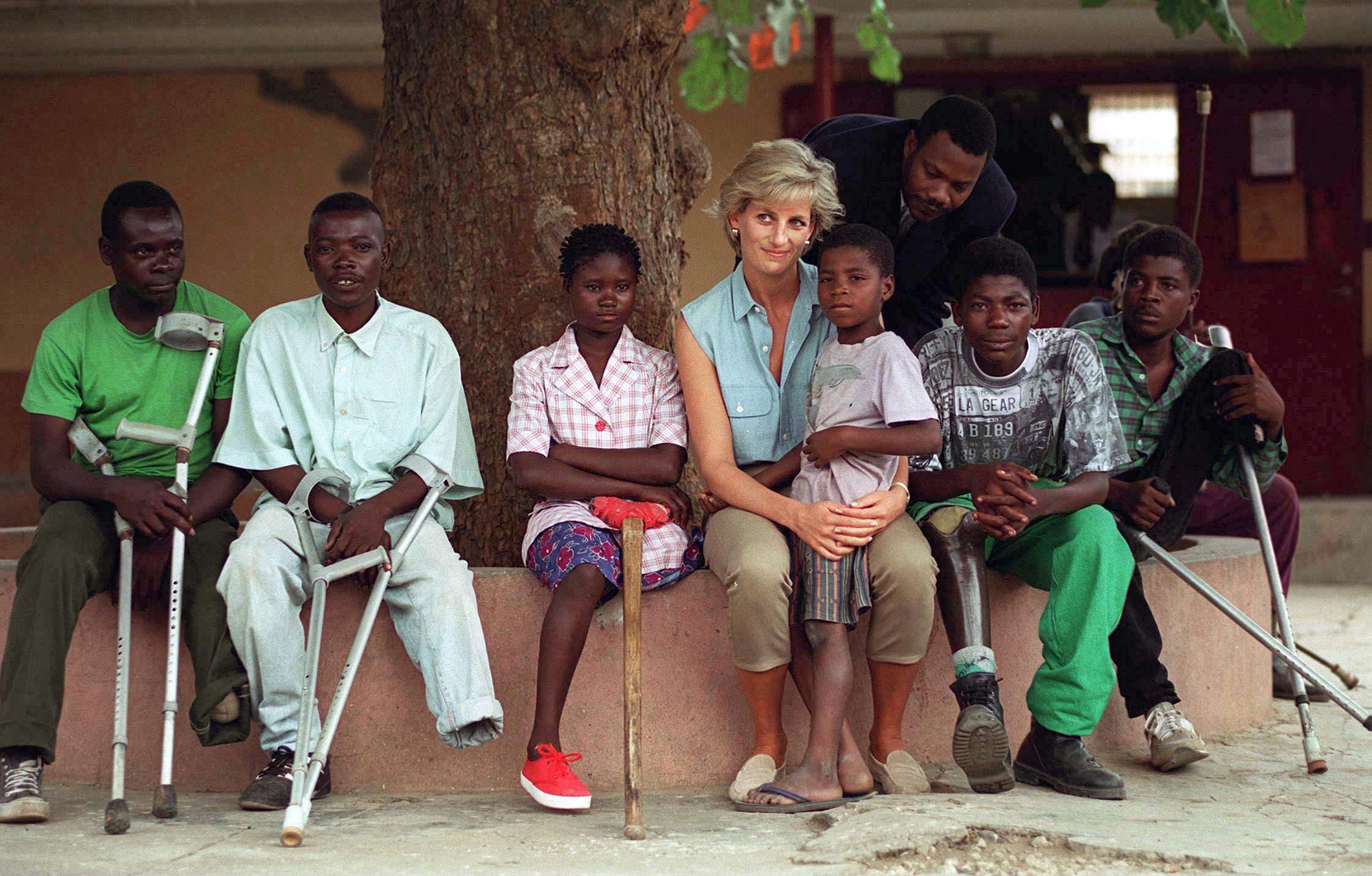 Princess Diana sitting with mine victims in Angola
