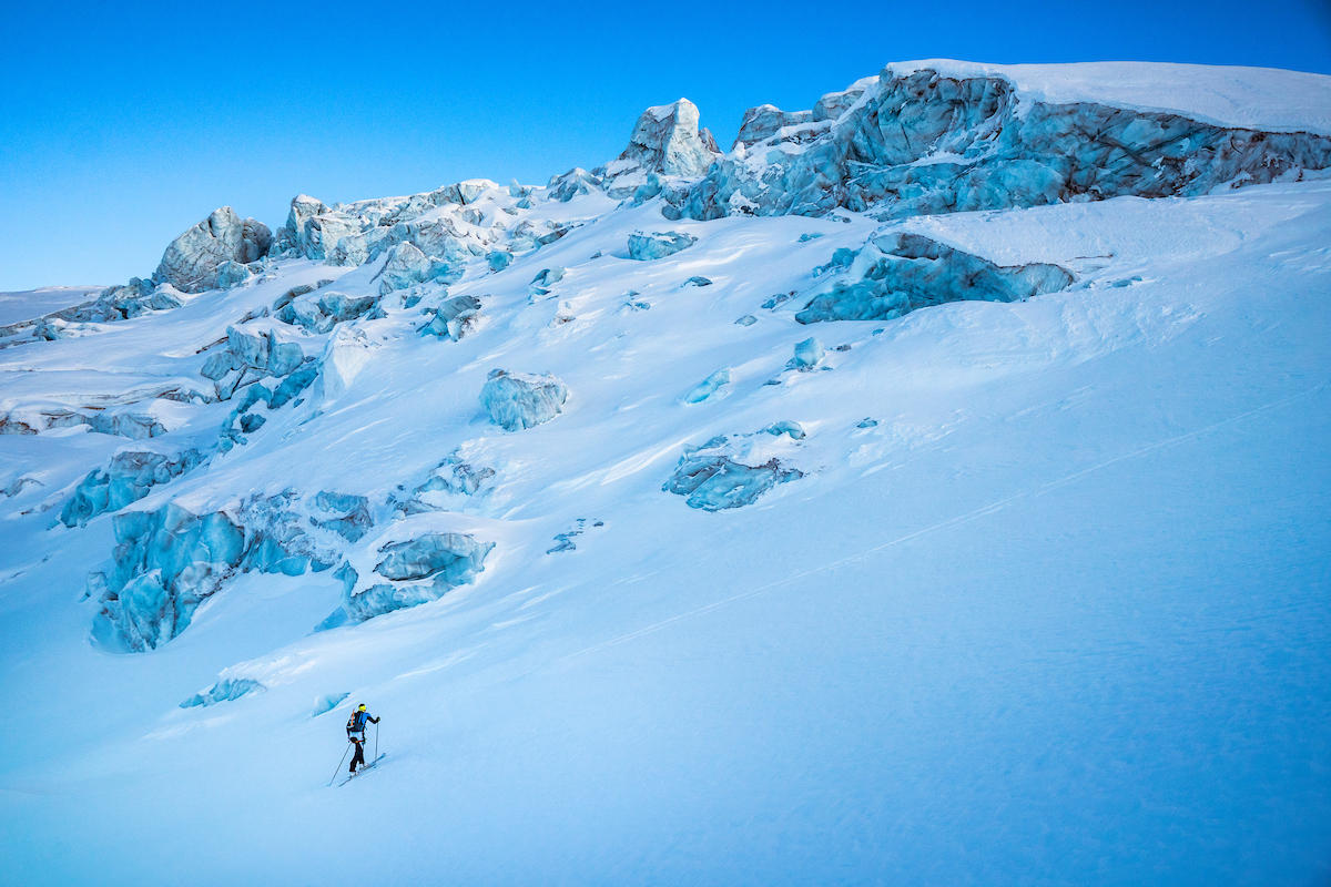 Ski tourer climbing a mountain slope