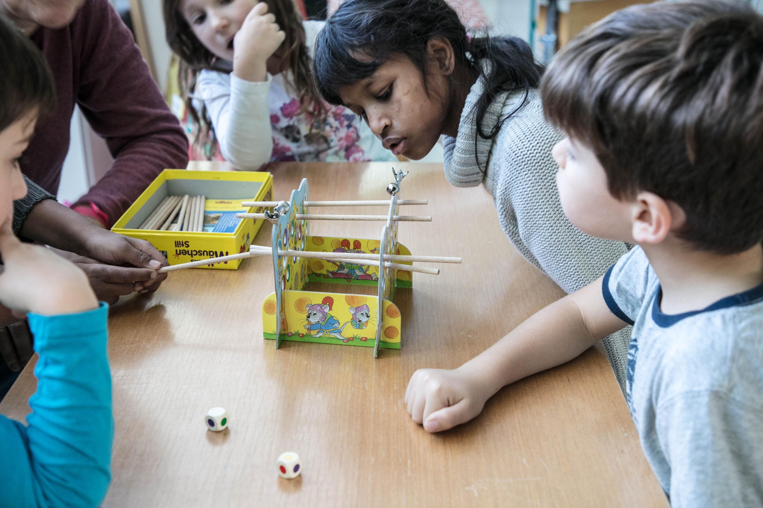 Schoolchildren gather around a table with an educational project