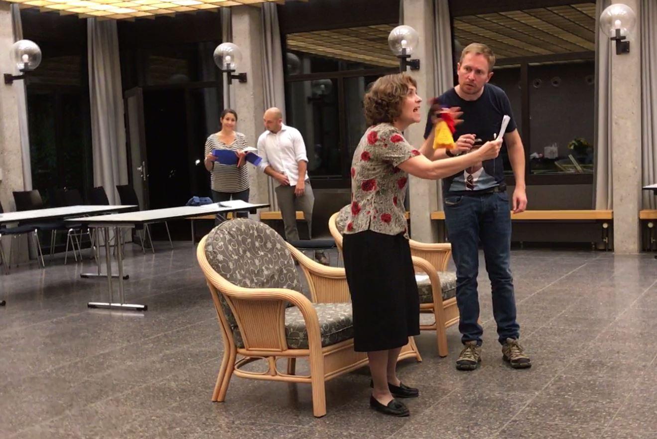Actors rehearse a scene from a play
