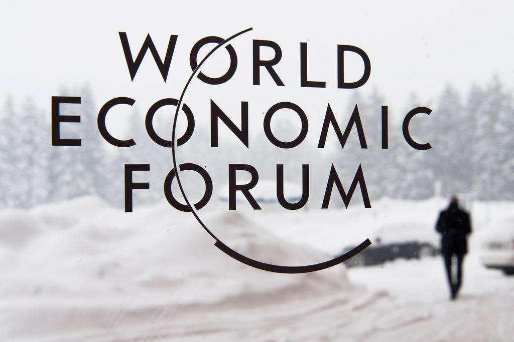 WEF logo on a screen in front of winter landscape
