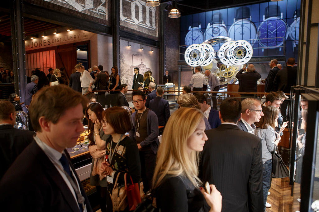 Visitors gather at the IWC booth, during the Open day at SIHH watch fair in Geneva