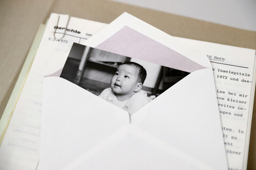 An image of a child who has been put up for adoption lies in an envelope in the Bern City Archives 