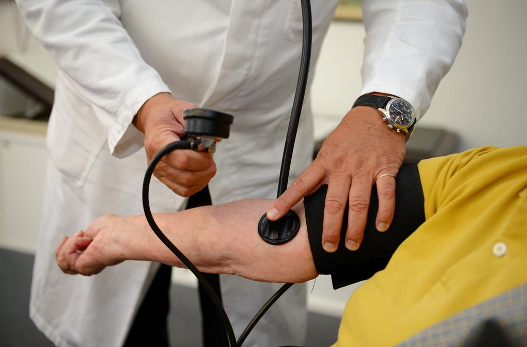 Closeup of doctor taking patient s blood pressure